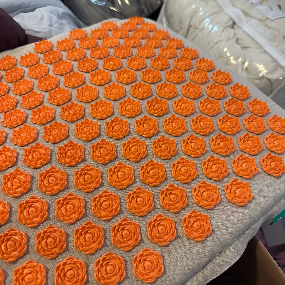 Pranamat Eco massage set with pillow, orange on natural.